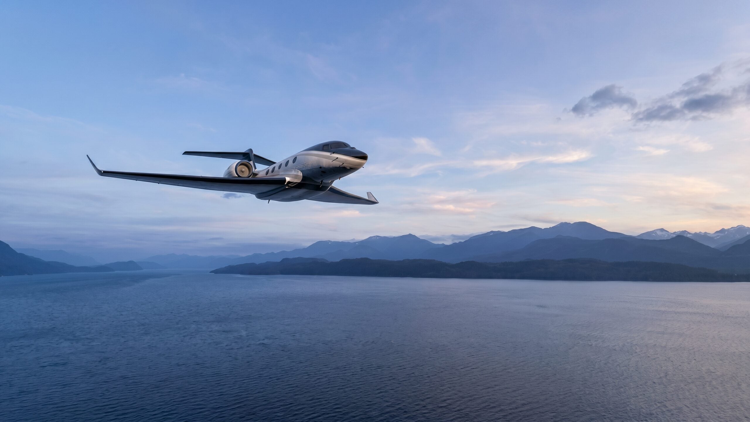A private jet in flight above a Greek coastline at dusk